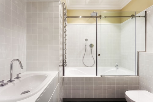 A classic bathroom interior with an alcove tub and a sink.