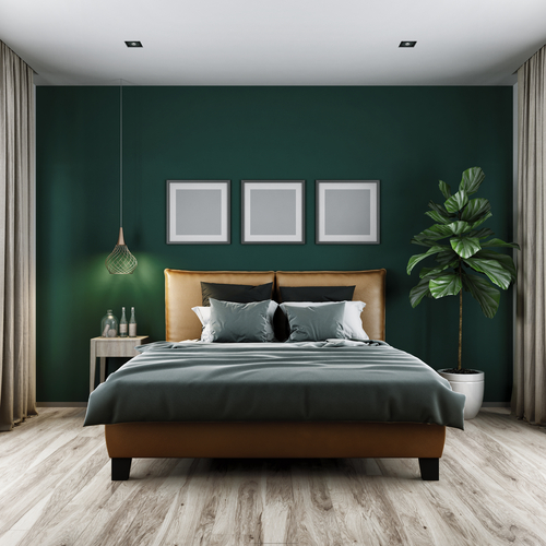 dark green accent wall in a bedroom with some earth tone elements