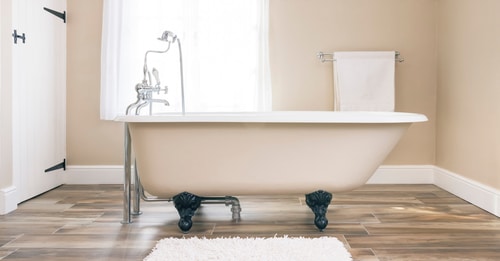 A regular sized beige bathtub.