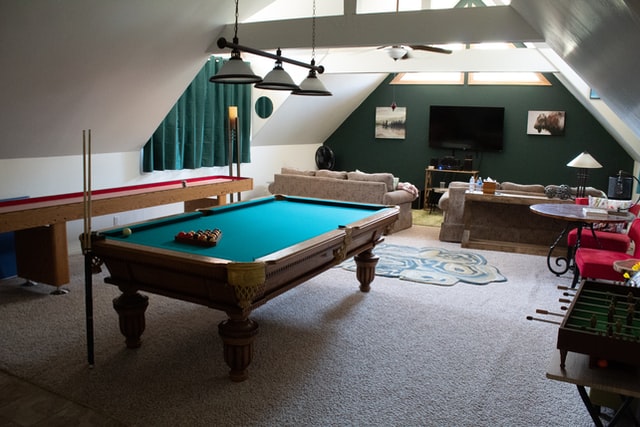A large pool table inside the billiard room in the attic.