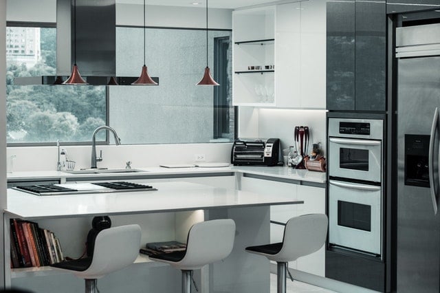 A bright white kitchen with black accents.