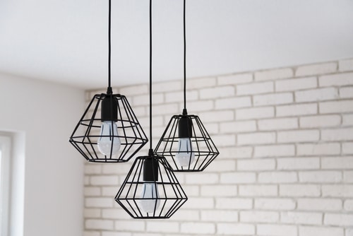 A set of black industrial pendant lights.