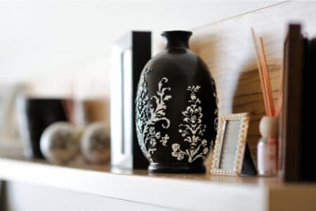 6 Tips For Perfectly Decorated Shelves Elegant black vase on an open shelf.