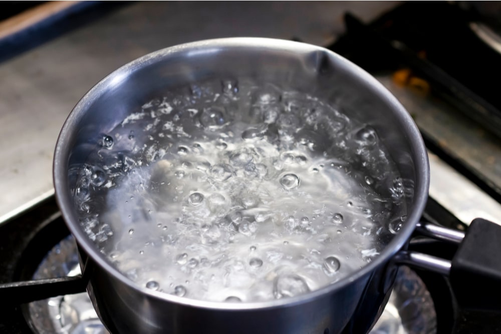 A pan of boiling water in the kitchen.