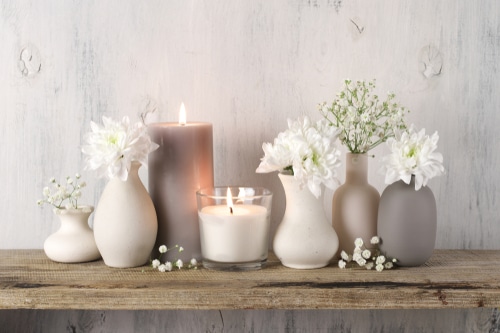 Natural and light colored flower vases and candles.
