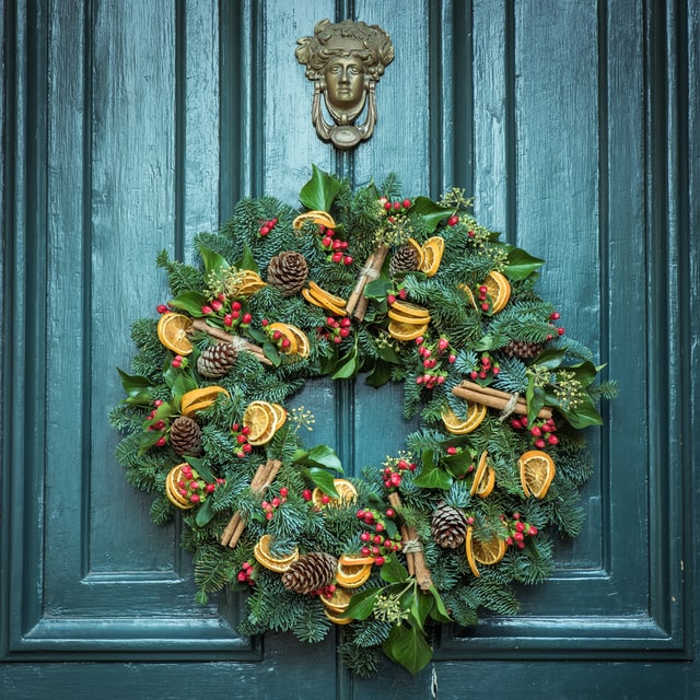 A christmas wreath placed on the front door