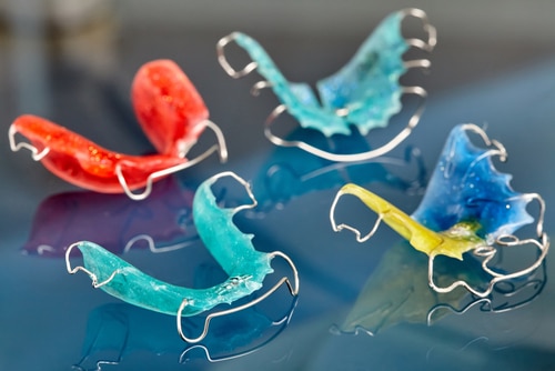 4 colorful dental retainers.