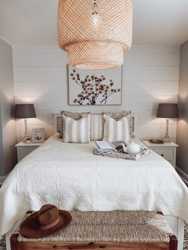 A very casual, laid-back but cozy cottage bedroom with wooden and woven textures.