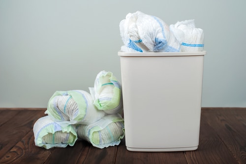 Used diapers thrown in a disposing plastic bin