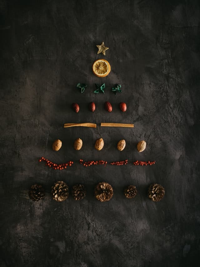 a diy christmas tree made up of assorted ornaments
