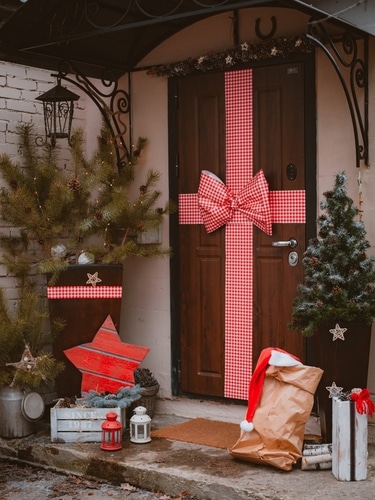 A front door turned into a large gift using gift ribbons