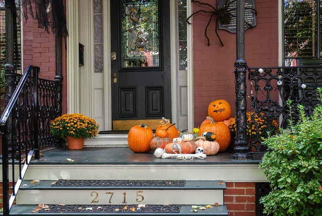 front door spiders Halloween decorations with pumpkins, spiders and spiderwebs