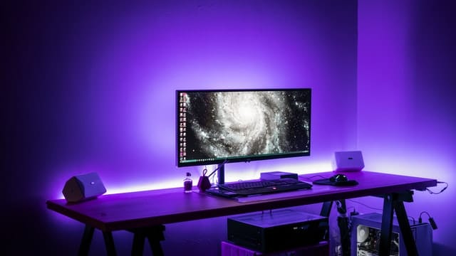 A gaming computer setup with violet LED lights