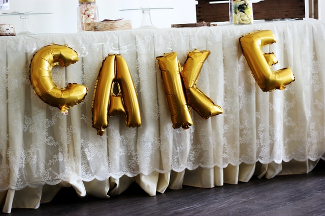 Gold mylar balloons of the word cake