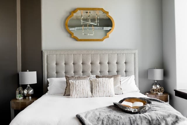 gray tufted headboard Gray tufted headboard with an overhead mirror
