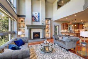 A modern living room with high ceiling and fireplace