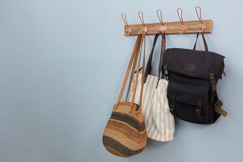A wooden hook rack for as bag hangers.