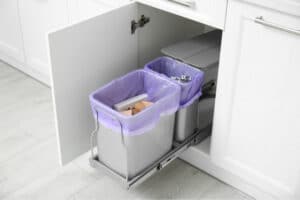 An in-cabinet pullout trash bin.