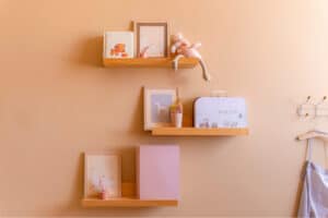 peach walls on kids room floating shelves