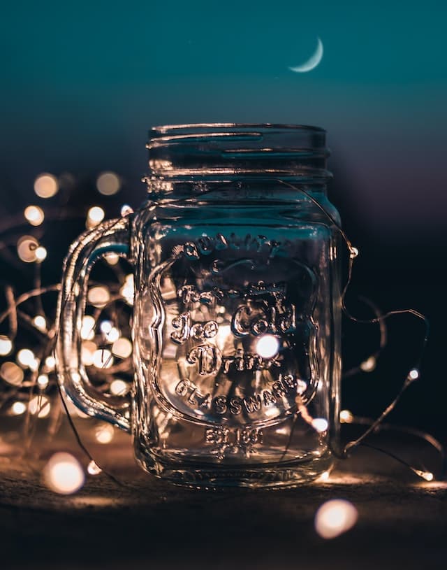 a small glass jar with string lights