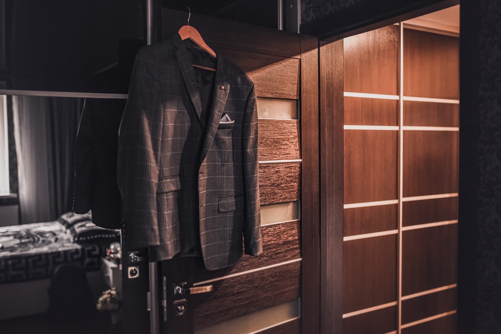 Suit hanging next to a moody bedroom