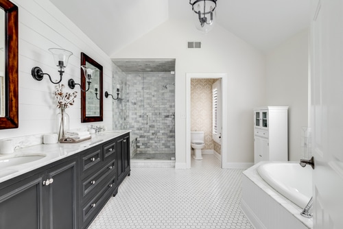 A huge, complete, and modern white bathroom with minimal styling.