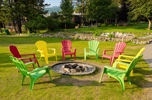 simple outdoor fireplace with colorful chairs