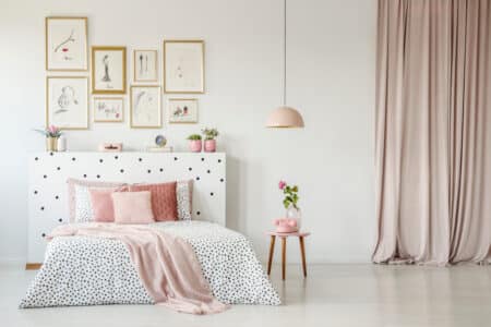 pink blanket on polka dots bed