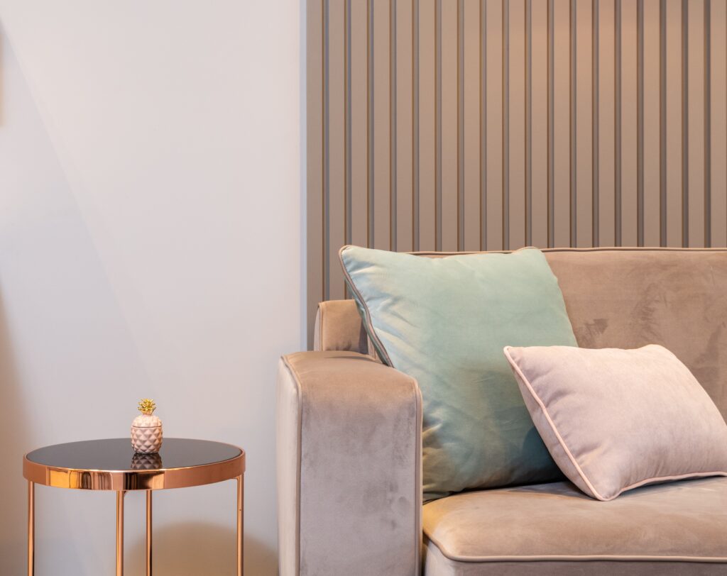 velvet couch with a pink and green pillow