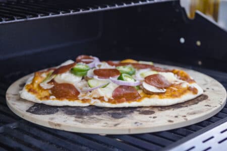 A pizza inside an outside grill