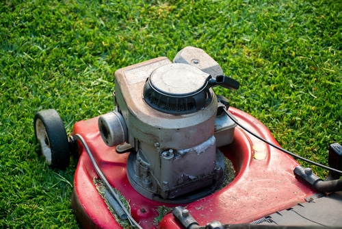 A red lawnmower ready to trim some grass