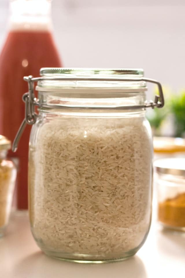 A clear glass jar as rice container