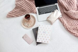 Rose quart blanket with a rose gold iphone and laptop