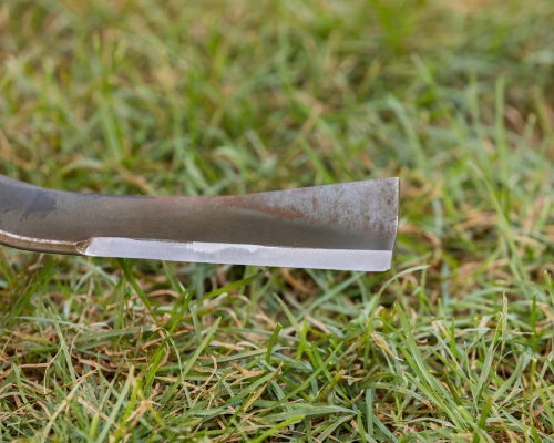 A detached sharp blade from a lawn mower