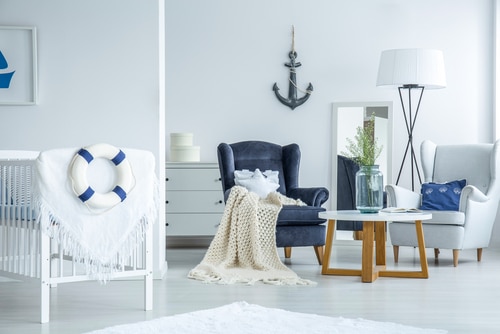 A simple white room decorated with ship elements like a blue anchor and lifebouy.