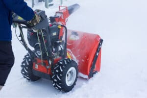 A man pushing the snow blower
