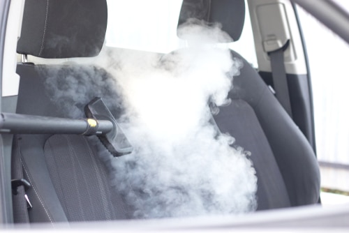 Steam cleaning the back seats of a car