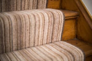 Warm colored stair carpet with striped pattern