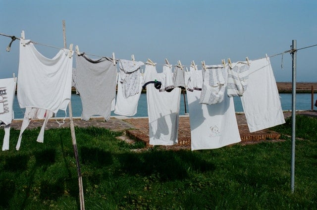 sun drying clothes Drying washed clothes on a clothesline under the sun.