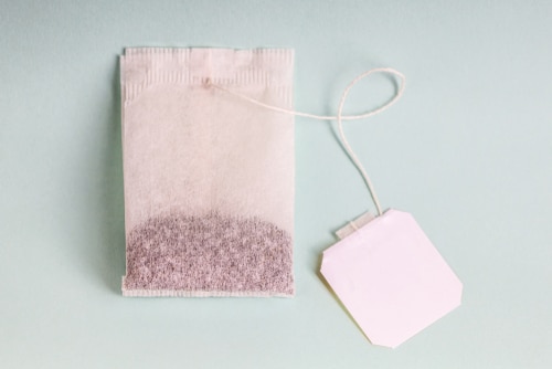 One tea bag with a label tag holder