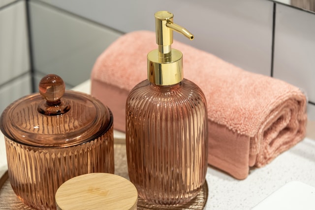 tinted glass bottles as soap dispensers and cotton holders bathroom