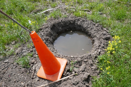 traffic cone ground hole An orange traffic cone ass marking for a deep ground hole