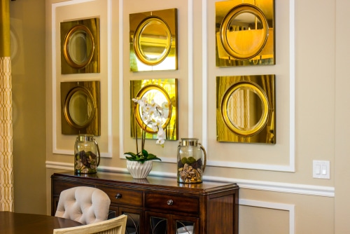 wall art A modern dining area with hanging golden art displays.