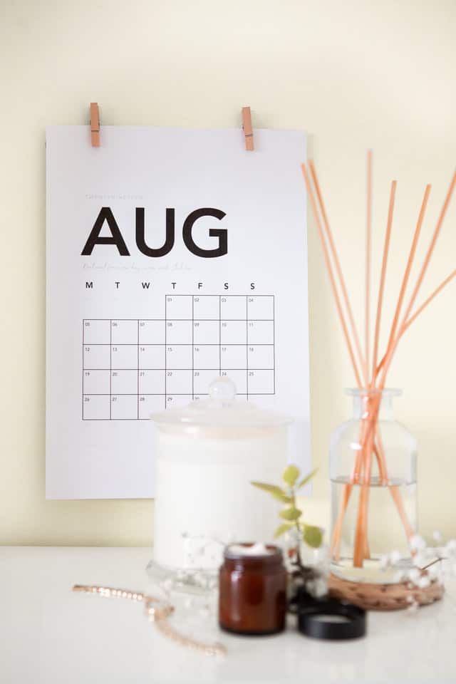 A large wall calendar display as a background of set of scented candles