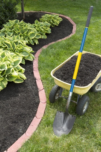 wheelbarrow and shovel wheelbarrow and shovel beside a garden landscape