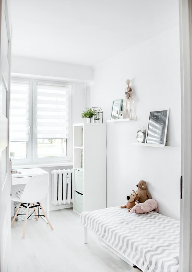 A narrow and white kids bedroom
