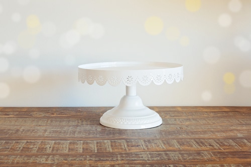 white cake plate A simple white cake plate over a wooden table.