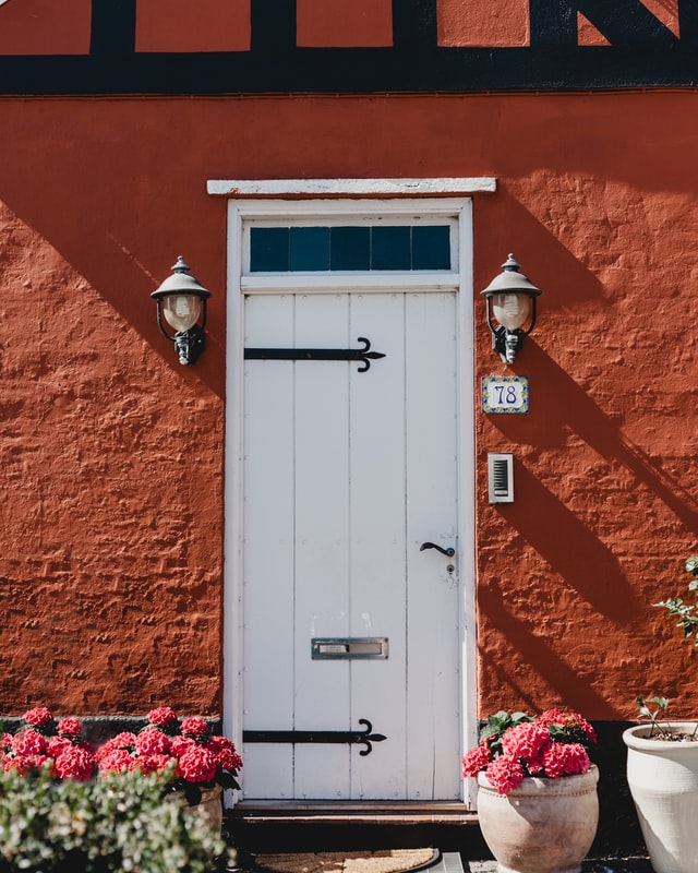 white door A white barn styled door against a rich terracotta colored wall paint.