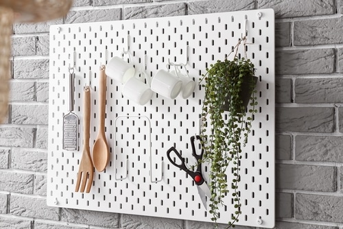 White kitchen pegboard with utensils