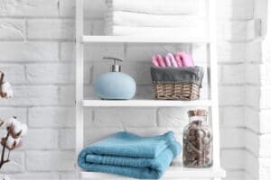 A white ladder shelf with bathroom materials